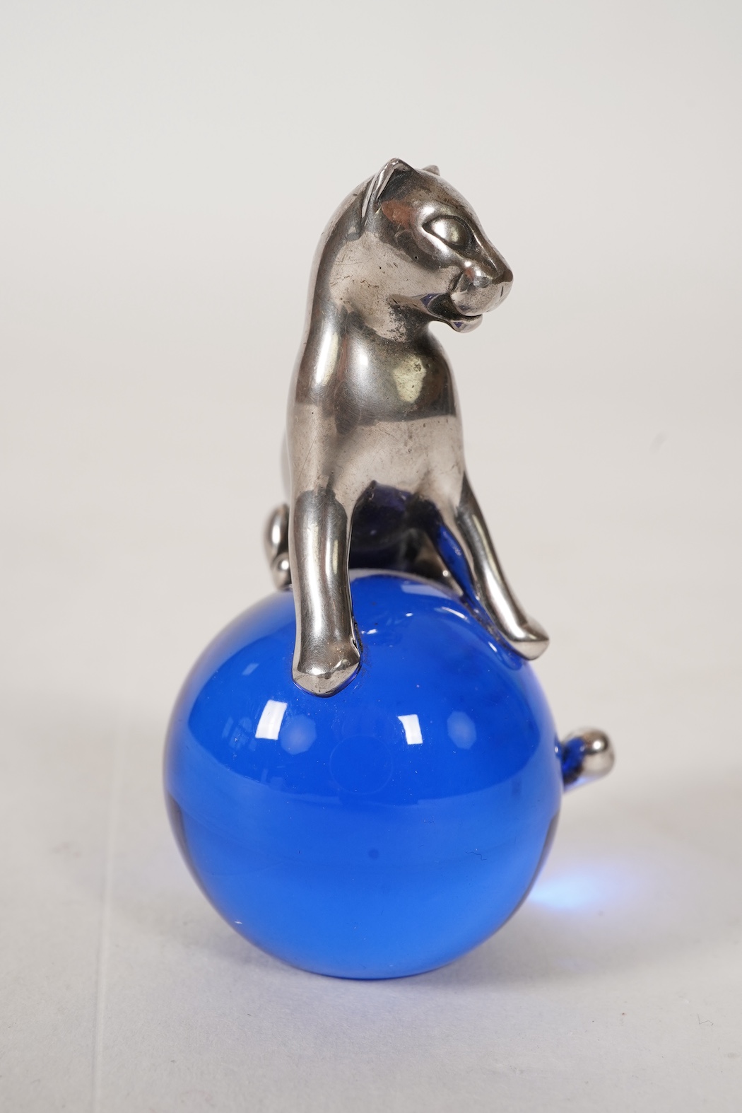 A recent Cartier paperweight, modelled as a panther upon a blue glass sphere